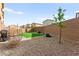 Backyard with low maintenance gravel and artificial turf, plus a covered patio with egg chair at 1783 Matteo Cove Pl, North Las Vegas, NV 89084