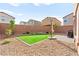 Backyard with low maintenance gravel and pavers, with a small patch of artificial turf at 1783 Matteo Cove Pl, North Las Vegas, NV 89084