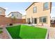 Green backyard space with artificial turf and low maintenance landscaping at 1783 Matteo Cove Pl, North Las Vegas, NV 89084