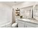Bathroom with a granite countertop, decorative shelves, and a shower-tub combination at 1783 Matteo Cove Pl, North Las Vegas, NV 89084