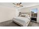 Bright bedroom with neutral decor, a comfortable bed, and large windows offering serene views at 1783 Matteo Cove Pl, North Las Vegas, NV 89084
