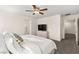 Comfortable bedroom features a ceiling fan, TV, neutral color palette, and inviting natural light at 1783 Matteo Cove Pl, North Las Vegas, NV 89084