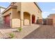 Home exterior featuring covered front entry with arched columns, gravel landscaping, and pathway at 1783 Matteo Cove Pl, North Las Vegas, NV 89084