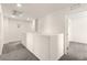 Upstairs hallway with neutral carpet and paint and an open doorway at 1783 Matteo Cove Pl, North Las Vegas, NV 89084