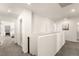 Bright hallway features neutral walls and carpets, complemented by modern lighting and doorways to bedrooms at 1783 Matteo Cove Pl, North Las Vegas, NV 89084