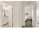 Hallway featuring doorways to a bathroom and bedroom, blending functionality with a bright and open feel at 1783 Matteo Cove Pl, North Las Vegas, NV 89084