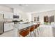 Kitchen with granite countertops, stainless appliances, island with bar seating, and dining table at 1783 Matteo Cove Pl, North Las Vegas, NV 89084