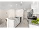 Kitchen island with granite countertops, stainless appliances, and white cabinets at 1783 Matteo Cove Pl, North Las Vegas, NV 89084
