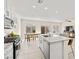 Kitchen island with granite countertops and stainless appliances that opens to the dining and living areas at 1783 Matteo Cove Pl, North Las Vegas, NV 89084
