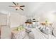 Bright living room featuring tile floors, a ceiling fan, and open access to the modern kitchen at 1783 Matteo Cove Pl, North Las Vegas, NV 89084