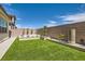 This backyard boasts beautiful landscaping, a lush lawn, and a custom fountain at 182 Robledo St, Las Vegas, NV 89138
