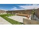 Landscaped backyard with modern patio, lush greenery, and stylish seating area at 182 Robledo St, Las Vegas, NV 89138