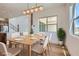 Dining room with an abundance of natural light, a modern chandelier, and views to an adjacent living space at 182 Robledo St, Las Vegas, NV 89138