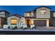 Inviting two-story home with warm exterior lighting and meticulously maintained landscaping at 182 Robledo St, Las Vegas, NV 89138