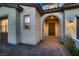 Detailed front entrance showcasing stone accents, an arched entryway, and stylish outdoor lighting at 182 Robledo St, Las Vegas, NV 89138