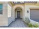 Elegant front entrance featuring stone accents, an arched doorway, and a covered porch at 182 Robledo St, Las Vegas, NV 89138