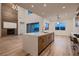 Open floor plan with modern kitchen, fireplace and large sliding glass doors to the backyard at 182 Robledo St, Las Vegas, NV 89138