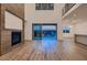 Open living room featuring a fireplace, light wood floors and views to the backyard space at 182 Robledo St, Las Vegas, NV 89138