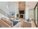 Bright open-concept living room with fireplace, high ceilings, and a staircase to the second floor at 182 Robledo St, Las Vegas, NV 89138