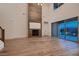 Open living room with fireplace and sliding glass doors that lead to an outdoor space at 182 Robledo St, Las Vegas, NV 89138