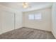 Cozy bedroom features neutral carpet and a window letting in natural light at 212 Orland St # 19, Las Vegas, NV 89107