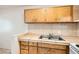 Bright kitchen featuring light wood cabinets and stainless steel sink at 212 Orland St # 19, Las Vegas, NV 89107