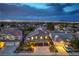 Scenic aerial view of a home in a neighborhood with city lights in the distance at 2248 Verde Cape Ave, Henderson, NV 89052