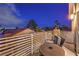 Balcony view at dusk with seating area and cityscape in the distance at 2248 Verde Cape Ave, Henderson, NV 89052