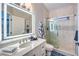 Modern bathroom showcasing a lighted mirror and glass-enclosed shower at 2248 Verde Cape Ave, Henderson, NV 89052
