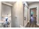 Upper hallway featuring wood-style floors, sliding barn door accents and views of a dining area below at 2248 Verde Cape Ave, Henderson, NV 89052