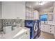 Functional laundry room with modern appliances, ample counter space, and stylish tiling for added convenience at 2248 Verde Cape Ave, Henderson, NV 89052