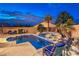 Inviting backyard pool and spa featuring decorative tiling, lush landscaping, and a relaxing ambiance for outdoor enjoyment at 2248 Verde Cape Ave, Henderson, NV 89052