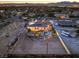 The backyard of this estate is highlighted in this aerial view, showing the pool, landscaping, and city lights beyond at 2780 El Camino Rd, Las Vegas, NV 89146