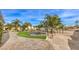 Lush backyard with mature trees, a fenced pool, and a large grassy area for outdoor activities at 2780 El Camino Rd, Las Vegas, NV 89146