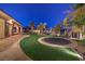 Expansive backyard with artificial turf, concrete patio and walkways, palm trees, and an in-ground trampoline at 2780 El Camino Rd, Las Vegas, NV 89146