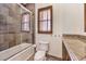 Bathroom featuring tiled shower with glass door, toilet, and vanity with granite countertop at 2780 El Camino Rd, Las Vegas, NV 89146