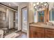 Bathroom featuring a tiled shower with glass door, toilet, and vanity with granite countertop at 2780 El Camino Rd, Las Vegas, NV 89146