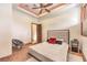 Comfortable bedroom with a ceiling fan, tiled floor, and a decorative red accent pillow on the bed at 2780 El Camino Rd, Las Vegas, NV 89146