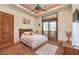 Well-lit bedroom featuring a ceiling fan, decorative rug, and a sliding glass door to the outside at 2780 El Camino Rd, Las Vegas, NV 89146