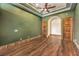 Well-lit bedroom featuring hardwood floors, arched doorway, and decorative wall trim at 2780 El Camino Rd, Las Vegas, NV 89146