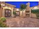 Cozy outdoor courtyard featuring a fireplace, outdoor seating, and lush landscaping, perfect for entertaining at 2780 El Camino Rd, Las Vegas, NV 89146