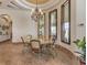 Bright dining room featuring a marble table, ornate chandelier, and large windows with wood trim at 2780 El Camino Rd, Las Vegas, NV 89146