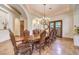 Formal dining room with a coffered ceiling, chandelier, and a long wooden table with upholstered chairs at 2780 El Camino Rd, Las Vegas, NV 89146