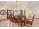 Elegant dining room with a chandelier, decorative mirror, and a large wooden table for gatherings at 2780 El Camino Rd, Las Vegas, NV 89146