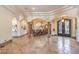Grand entryway with arched columns, travertine flooring, and an ornate wrought iron double door at 2780 El Camino Rd, Las Vegas, NV 89146