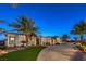 Elegant single-story home featuring a circular driveway, lush landscaping, and a grand entrance at 2780 El Camino Rd, Las Vegas, NV 89146