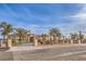 An exterior view of the home with a large gated driveway and mature landscaping in a desert environment at 2780 El Camino Rd, Las Vegas, NV 89146