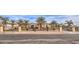 An exterior view of the home with a large gated driveway, mature landscaping, and a circular driveway at 2780 El Camino Rd, Las Vegas, NV 89146