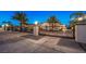 Elegant home featuring a gated entrance, lush landscaping, and a long driveway at 2780 El Camino Rd, Las Vegas, NV 89146