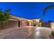 Spacious three-car garage with decorative driveway featuring gated access and desert landscaping at 2780 El Camino Rd, Las Vegas, NV 89146